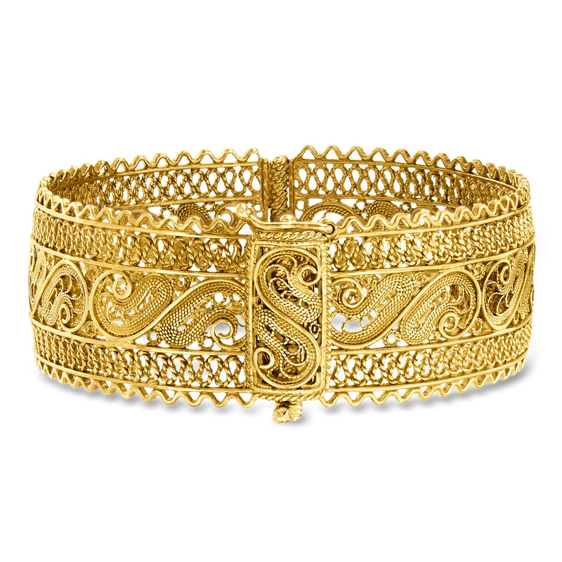 Wide gold filigree bangle bracelet with central clasp and ornate scrolling details