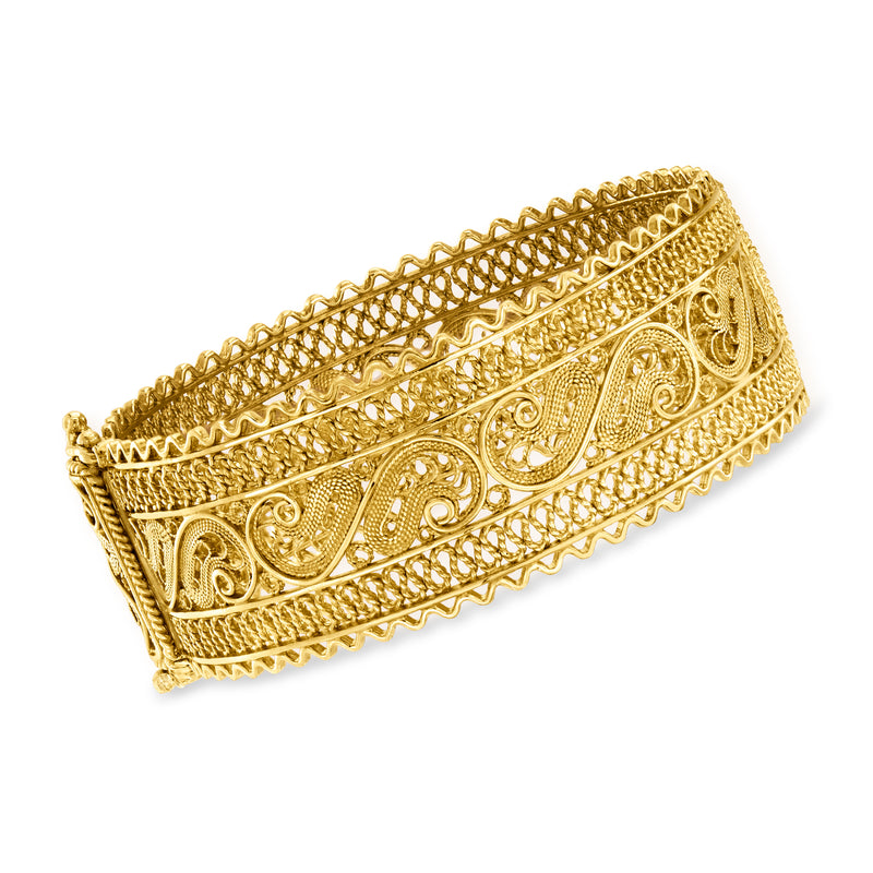 Wide gold filigree bangle bracelet, side view with engraved scrollwork panels