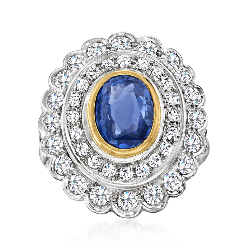 Two-tone gold ring with oval blue sapphire center and diamond double halo frame