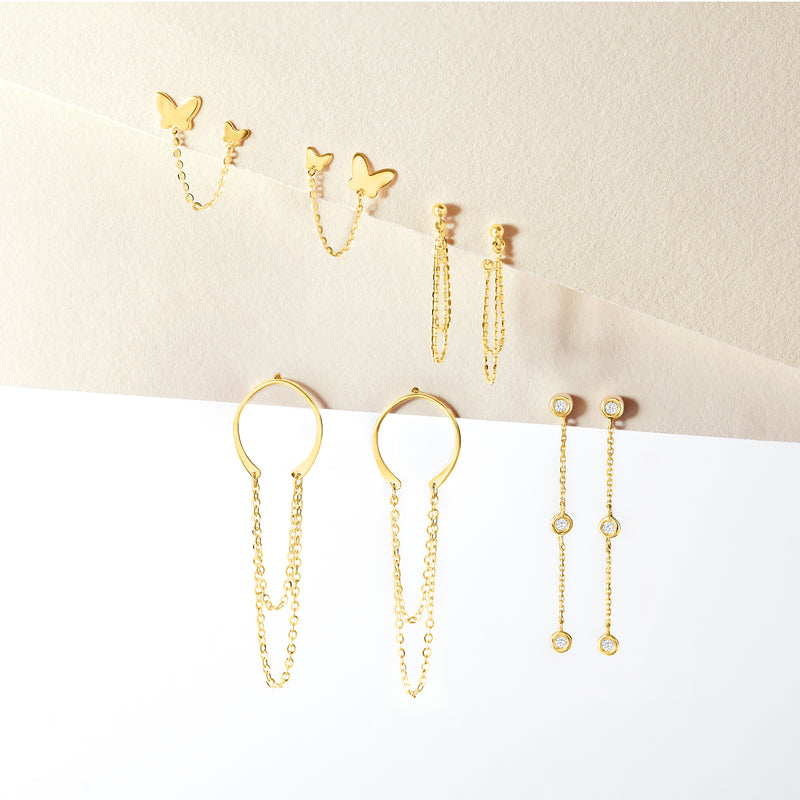 Yellow gold butterfly chain post earrings with small dangling chains, multiple pairs