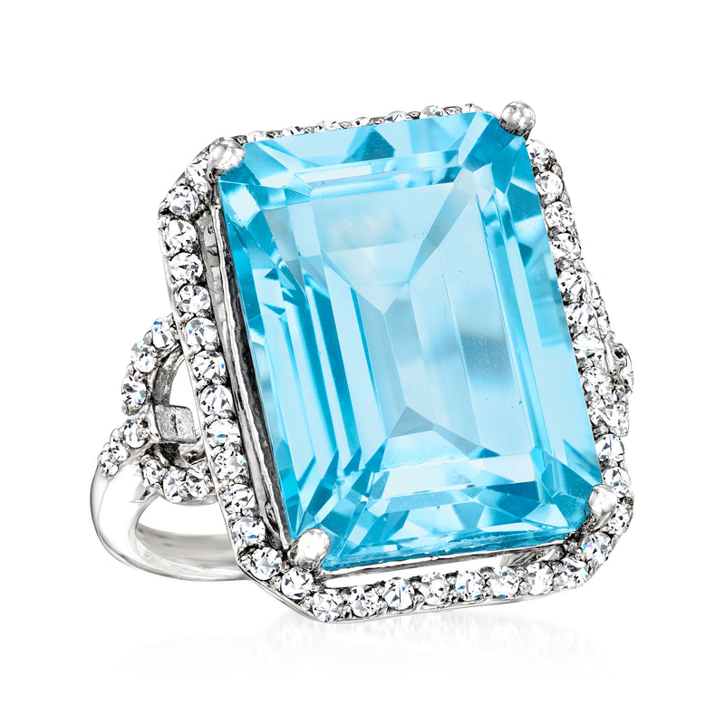 Sterling silver ring with rectangular step-cut blue topaz center and sparkling white topaz frame
