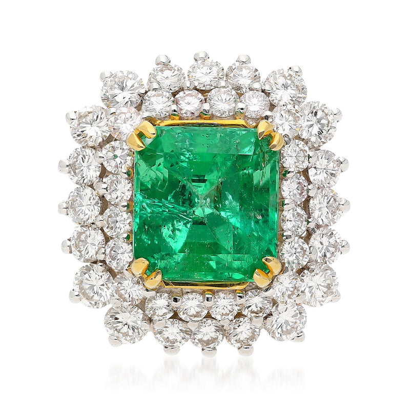 Emerald-cut green gemstone ring with diamond halo and yellow-gold prongs
