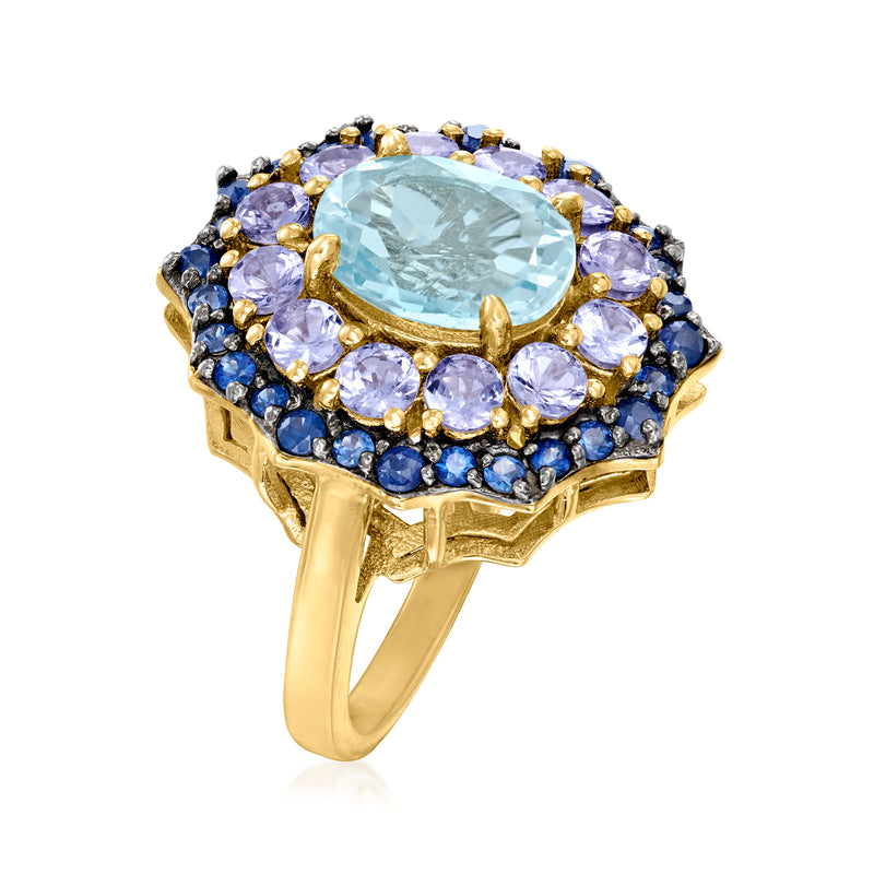Sky blue topaz ring, oval center stone in prong setting, blue and purple halo, gold band