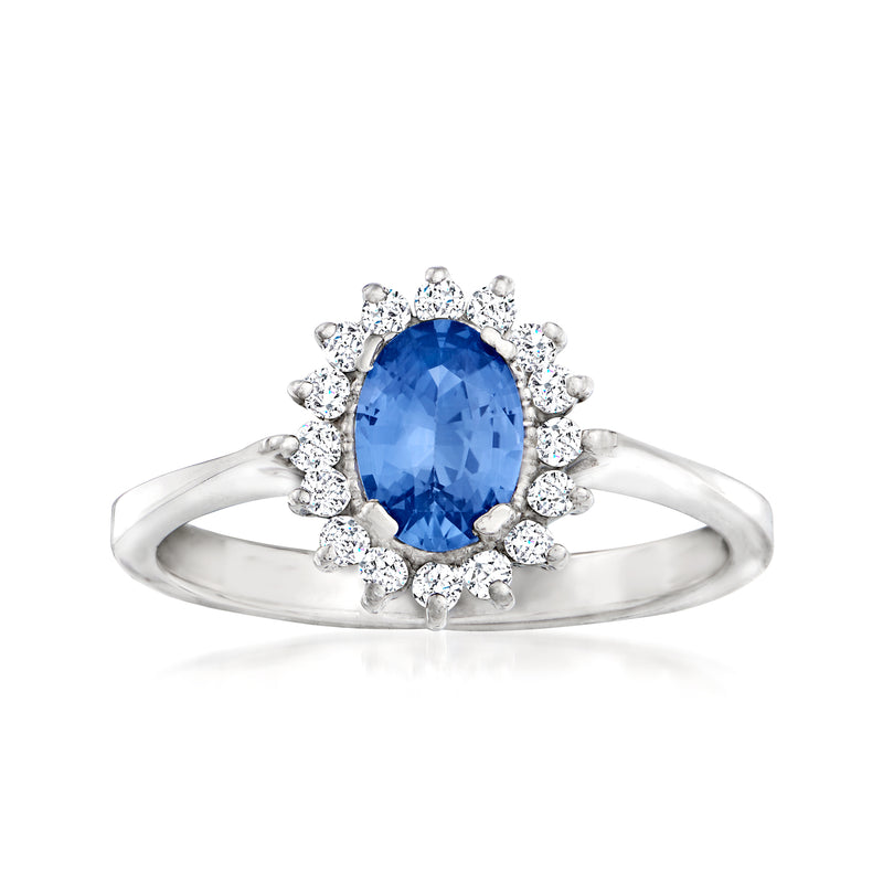 18k white gold sapphire halo ring with oval blue center and diamond cluster accents