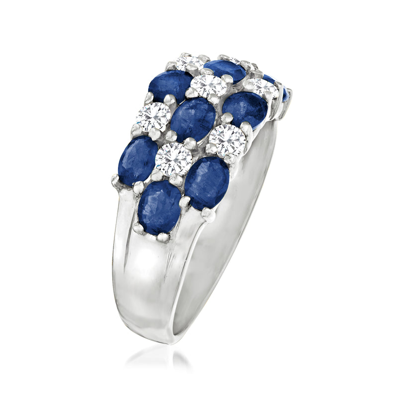 Side view white gold ring with oval blue sapphire settings and round diamond halos