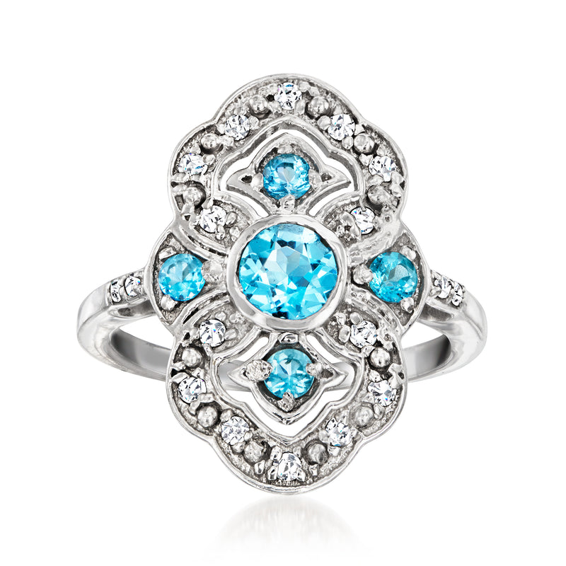 Sterling silver ring with oval Swiss Blue Topaz center, blue stones, and diamond halo