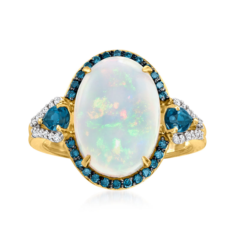 Oval opal ring in 14kt yellow gold with blue topaz halo and diamond accents