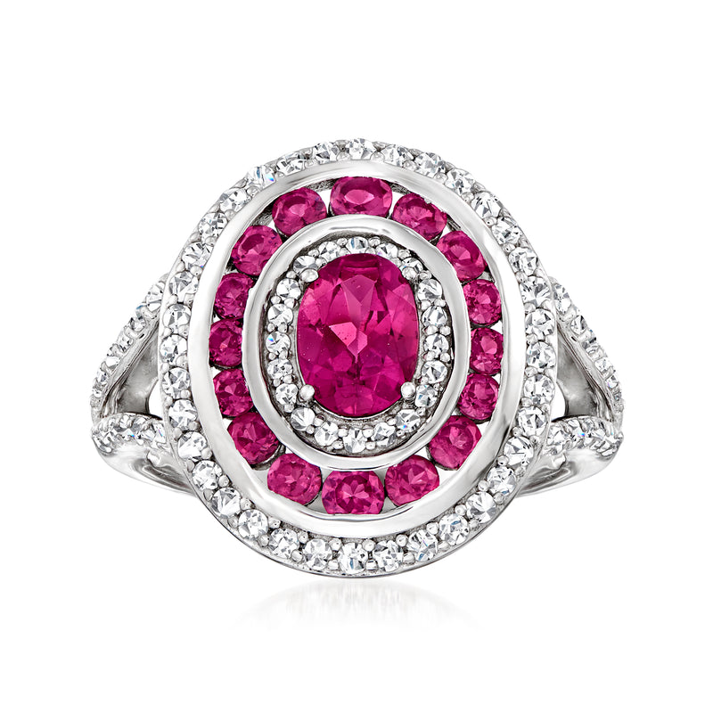 Sterling silver ring with oval pink rhodolite center, halo and white gemstone frame