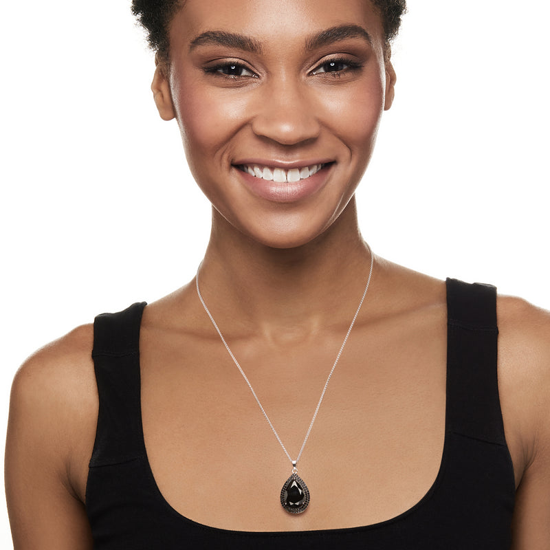 Black spinel teardrop pendant on fine sterling silver chain, worn on neckline