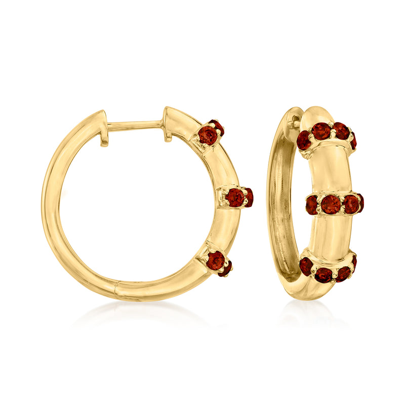 Gold hoop earrings with red garnet stones on the front and outer edge