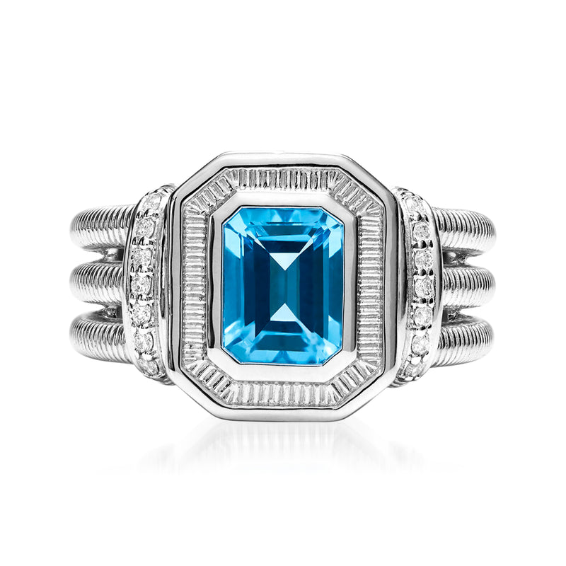 Sterling silver ring with rectangular blue topaz center and diamond-like accents