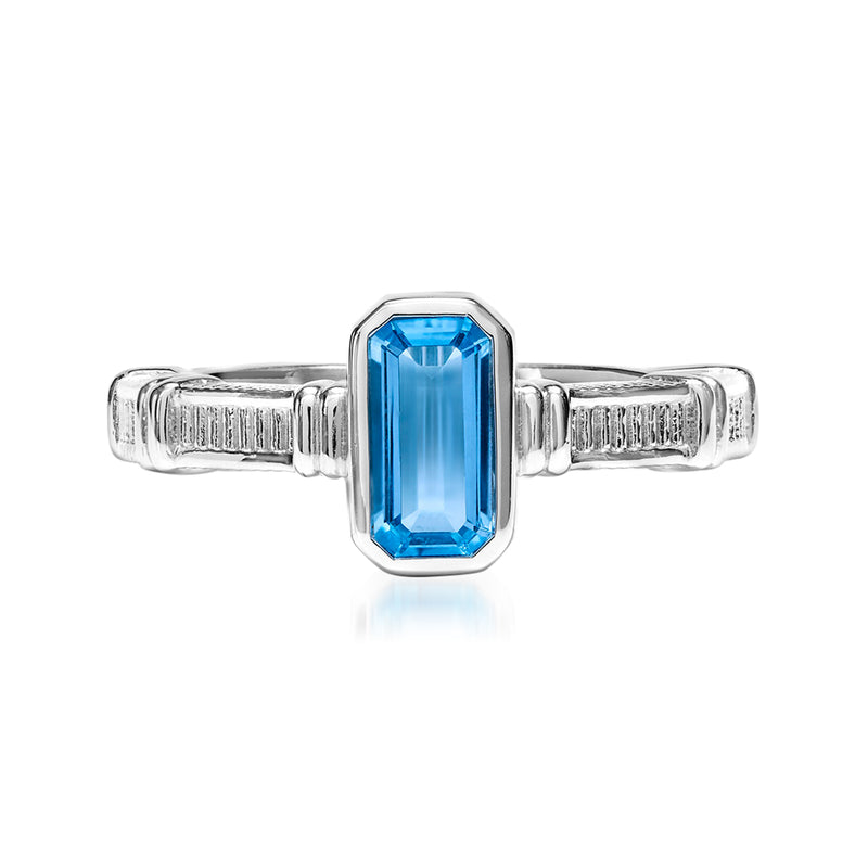 Sterling silver ring with rectangular blue topaz center stone and baguette side accents