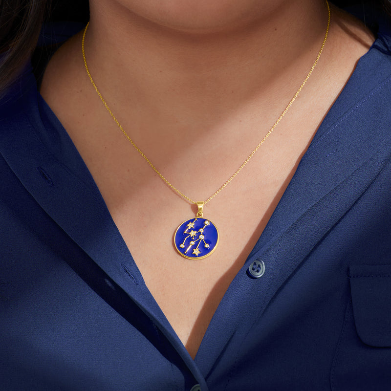 Gold-tone zodiac constellation pendant necklace with round blue enamel charm and zircon stars