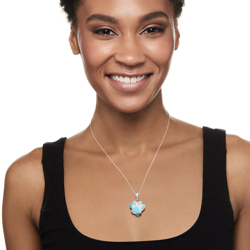 Turquoise paw print enamel pendant on fine silver chain necklace on model