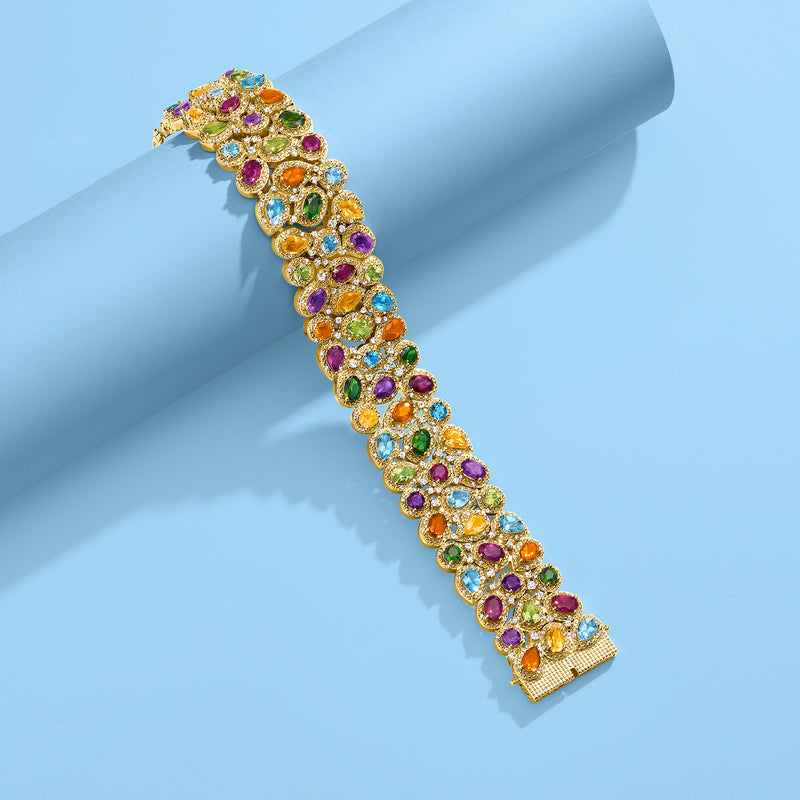 Gold-tone three-row gemstone bracelet with multicolor round stones along the band.