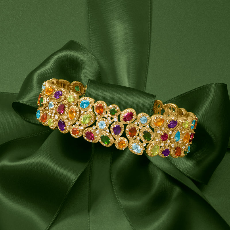 Gold-tone three-row bracelet with colorful round gemstones and ornate openwork links.