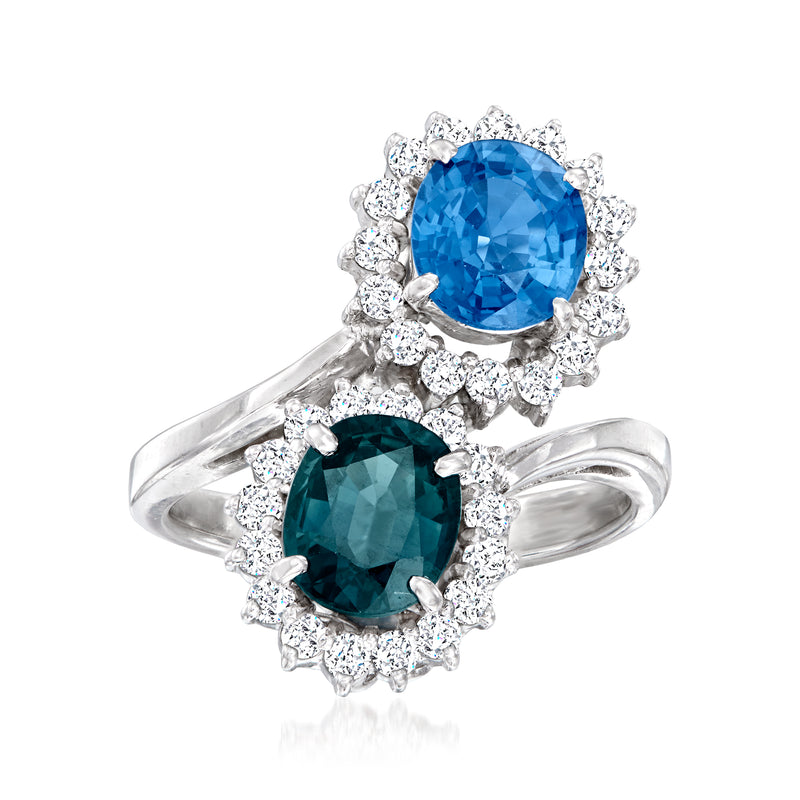 Platinum bypass ring with oval blue sapphire center stones and round diamond halos