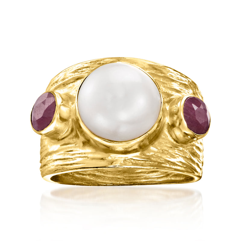 Gold-tone ring with round white pearl center and two purple ruby-style side stones