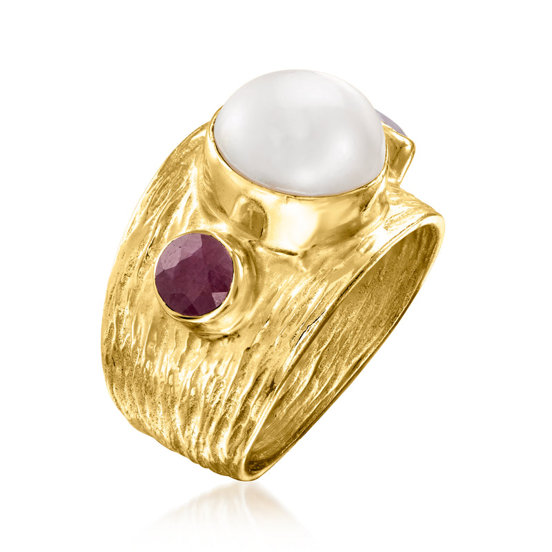 Gold-tone signet ring with white pearl bezel and purple oval side ruby