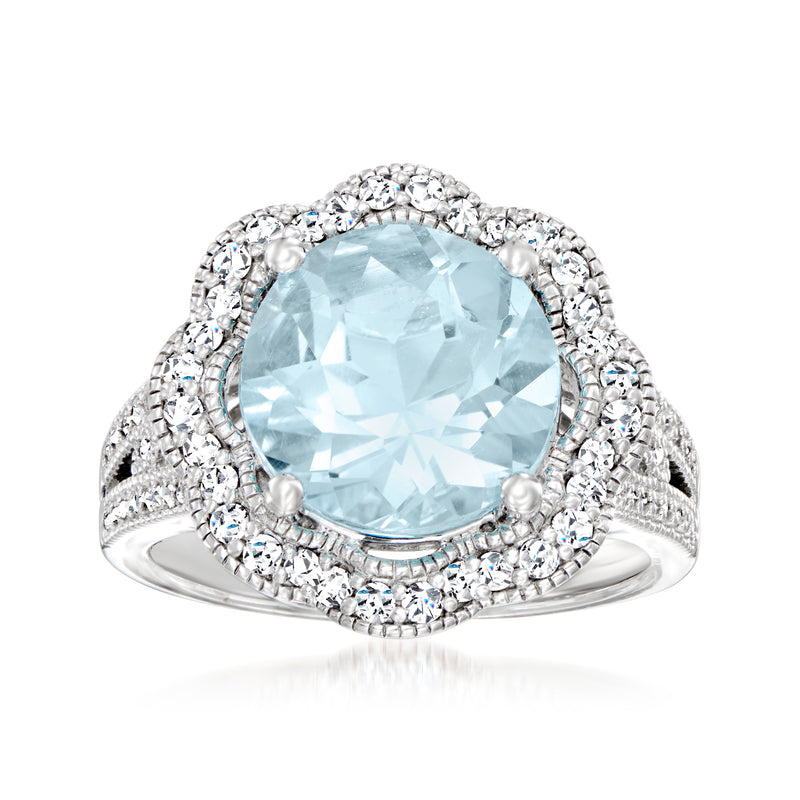 Sterling silver flower ring with sky blue topaz center and round diamond accents