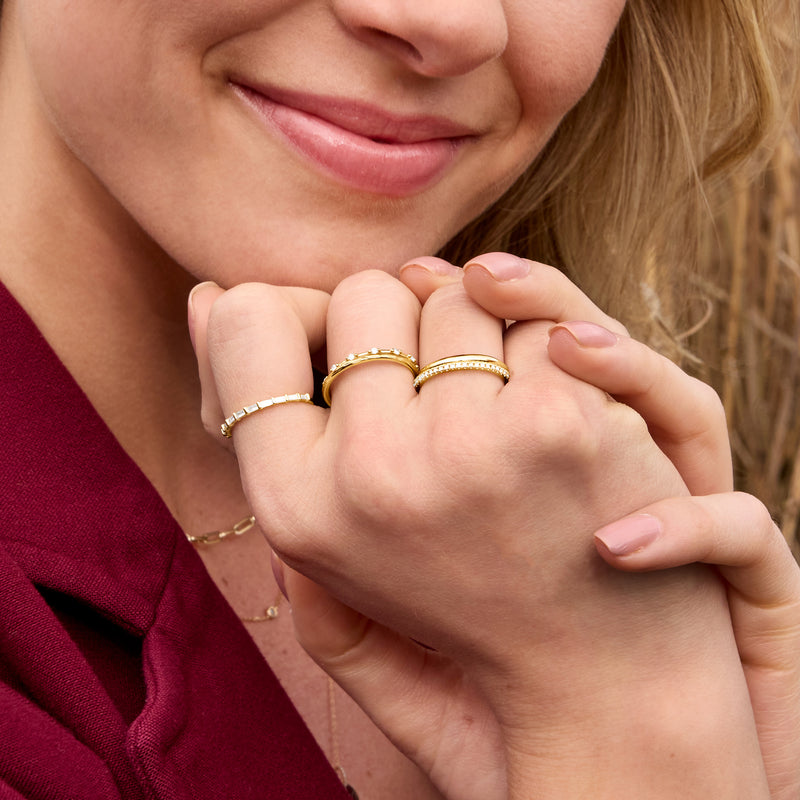 14kt yellow gold grooved band ring in stack on hand