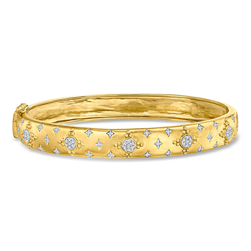 Gold over sterling bangle bracelet with diamond-like round and star cluster details.