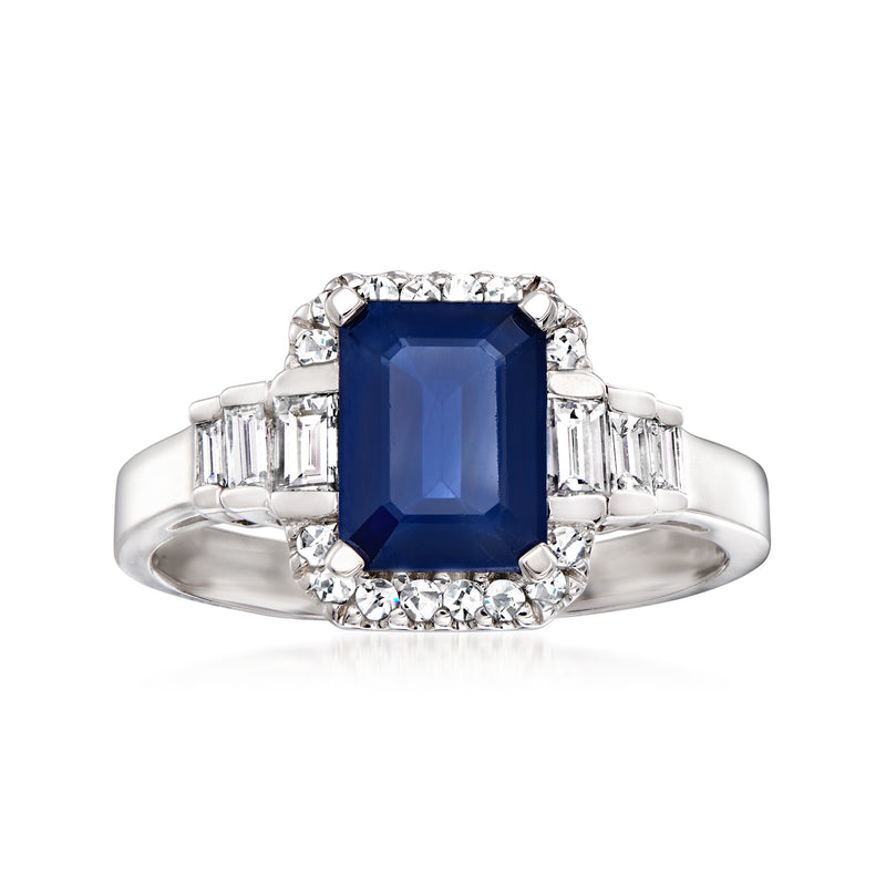 14kt white gold ring with dark blue square sapphire center and diamond halo, baguette sides
