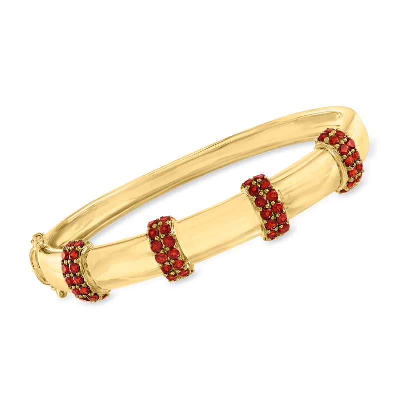 18kt gold over sterling bangle bracelet with three red garnet station clusters
