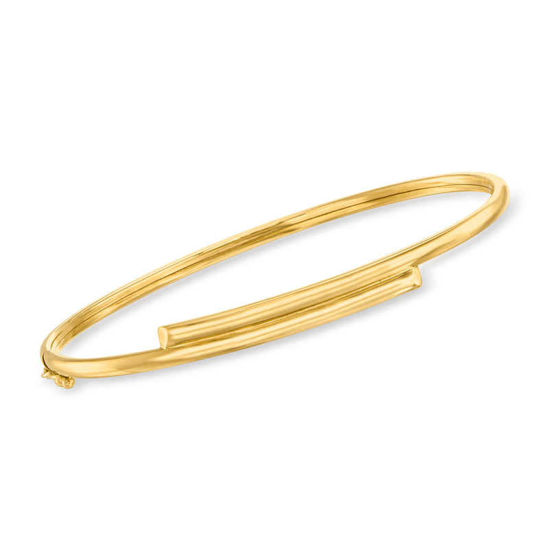 Oval yellow gold hinged bangle bracelet with decorative end accents