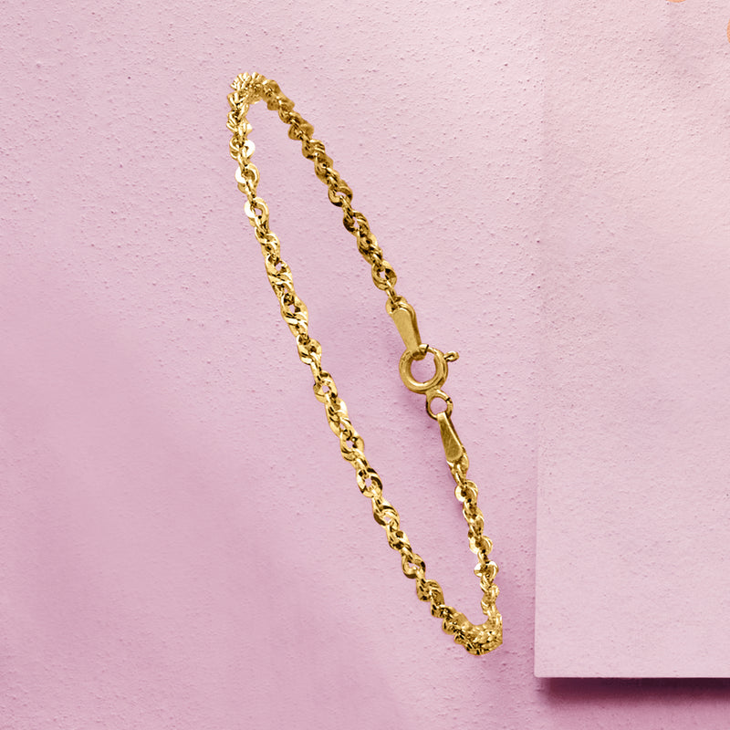 Yellow gold rope-chain bracelet close-up with round ring clasp
