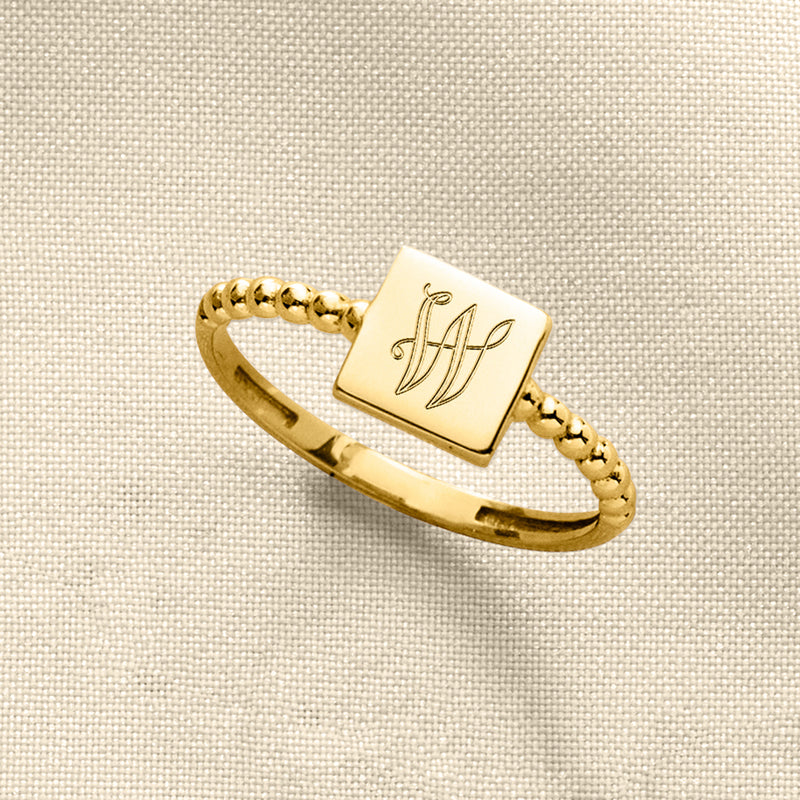 14kt yellow gold square beaded ring with engraved letter on glossy square top
