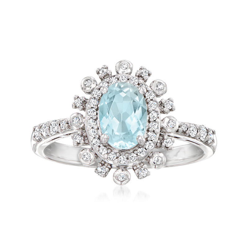 Sterling silver ring with oval aquamarine center and round diamond halo and shank accents