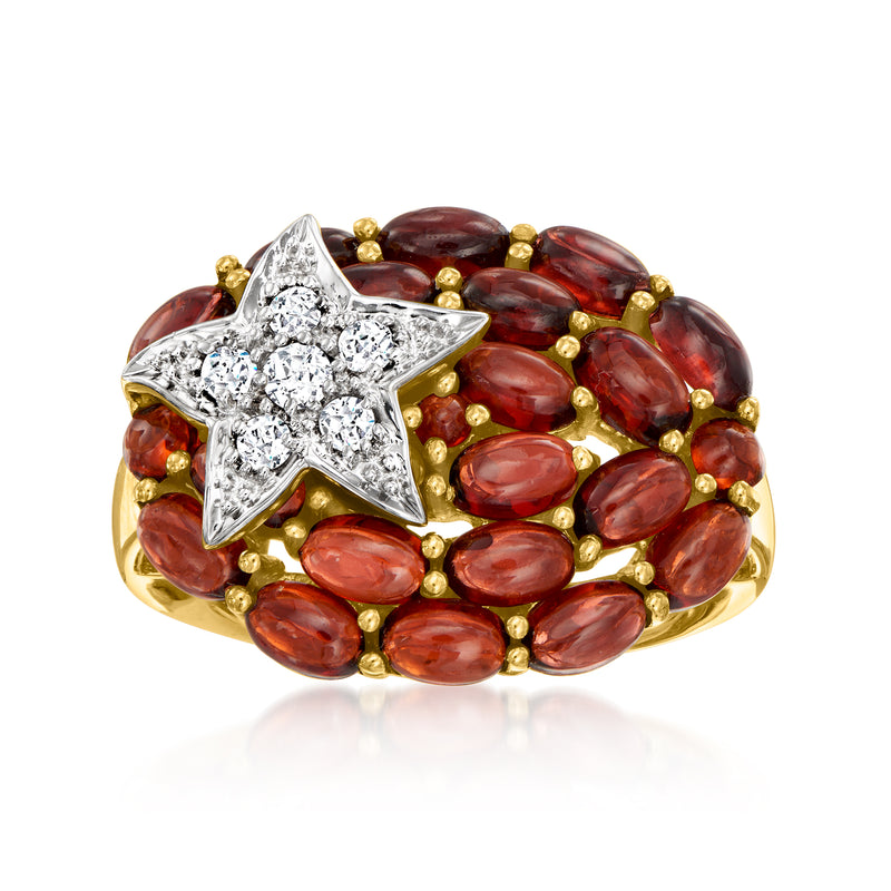 Gold-tone ring with large star centerpiece and red oval gemstone halo