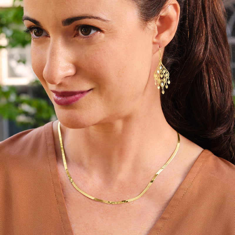 Yellow gold herringbone chain necklace on neckline