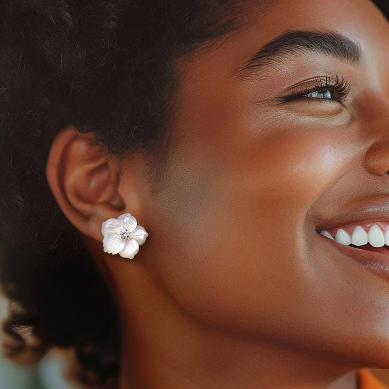 Mother-of-pearl flower stud earrings with round CZ center worn on ear