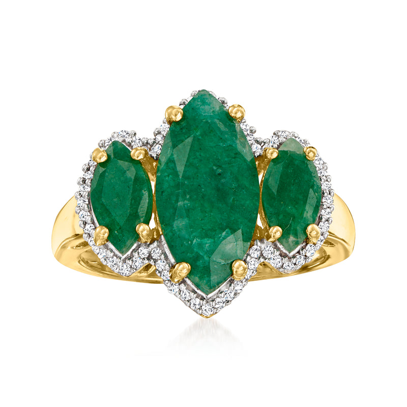 Emerald-green three-stone ring with gold prongs and diamond-look side stones