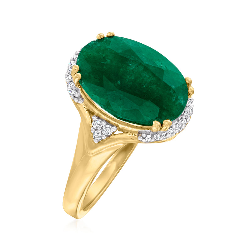 Gold emerald ring with faceted oval center stone, diamond shoulder accents, open prongs