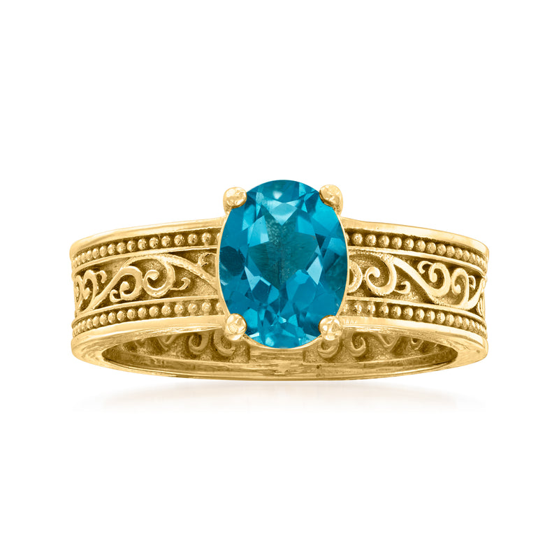 18kt gold over sterling ring with oval blue topaz and scrollwork bezel