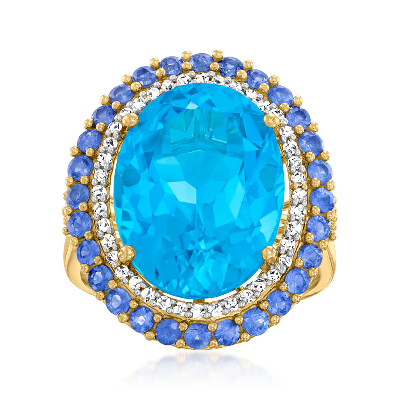 Oval blue topaz center with diamond halo and sapphire border ring in yellow gold