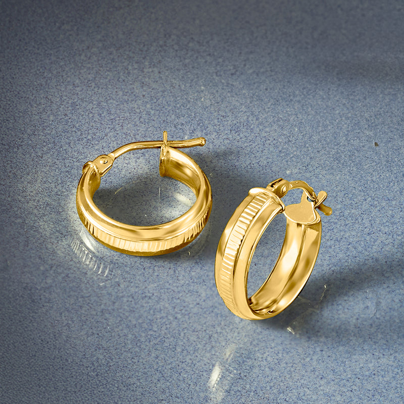 14kt yellow gold huggie hoops with ridged texture and hinge clasp, side view