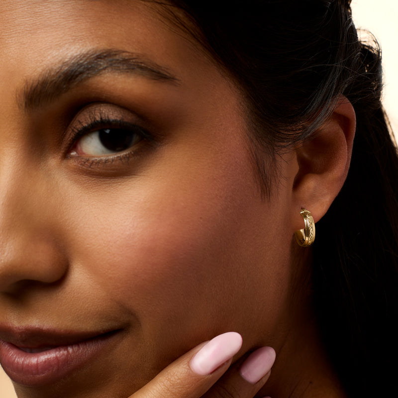 14kt yellow gold huggie hoop earring on ear, small ridged hoop with hinge