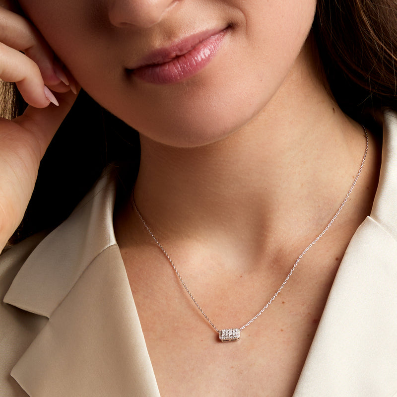 Sterling silver diamond cluster necklace worn at the neckline with rectangular halo pendant