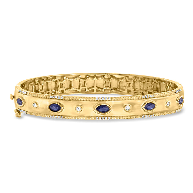 Gold bangle bracelet with blue oval gemstones and small diamond accents