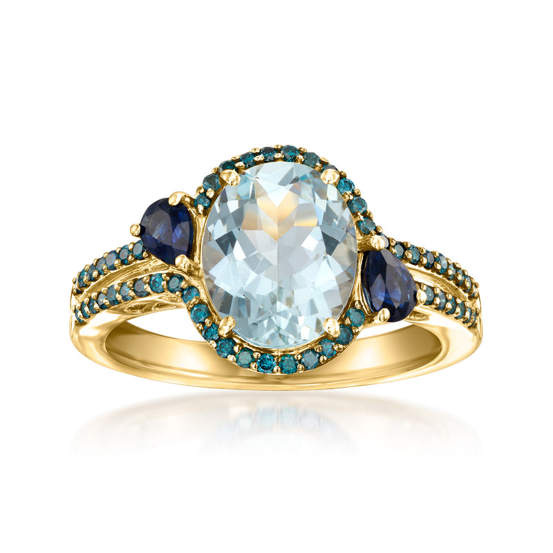 14kt yellow gold ring with oval aquamarine center, blue sapphire halo, pave sides