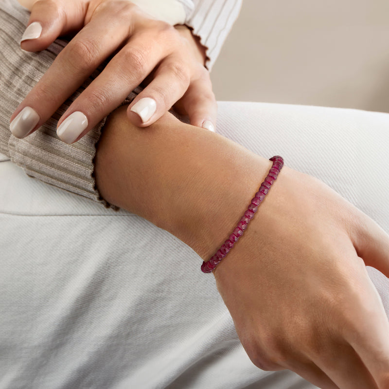 Ruby bead bracelet with gold magnetic clasp worn on wrist