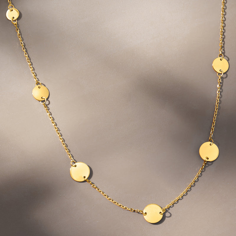 Yellow gold disc station necklace with varying-size round disc links