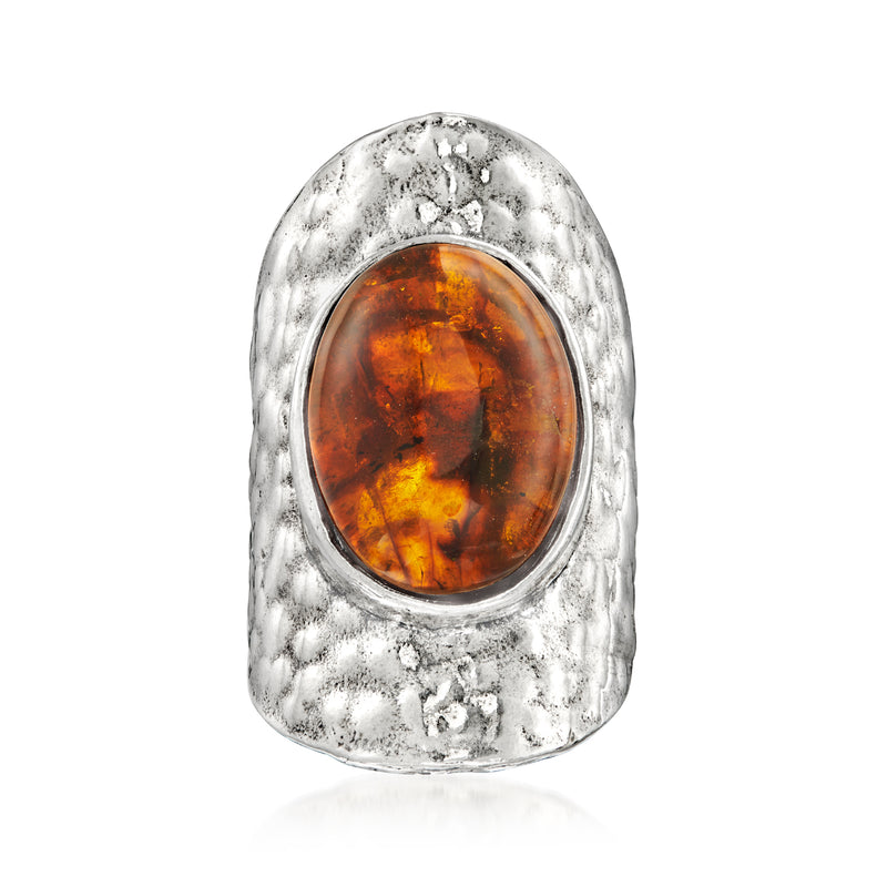Sterling silver amber oval cabochon ring with textured bezel and oval setting
