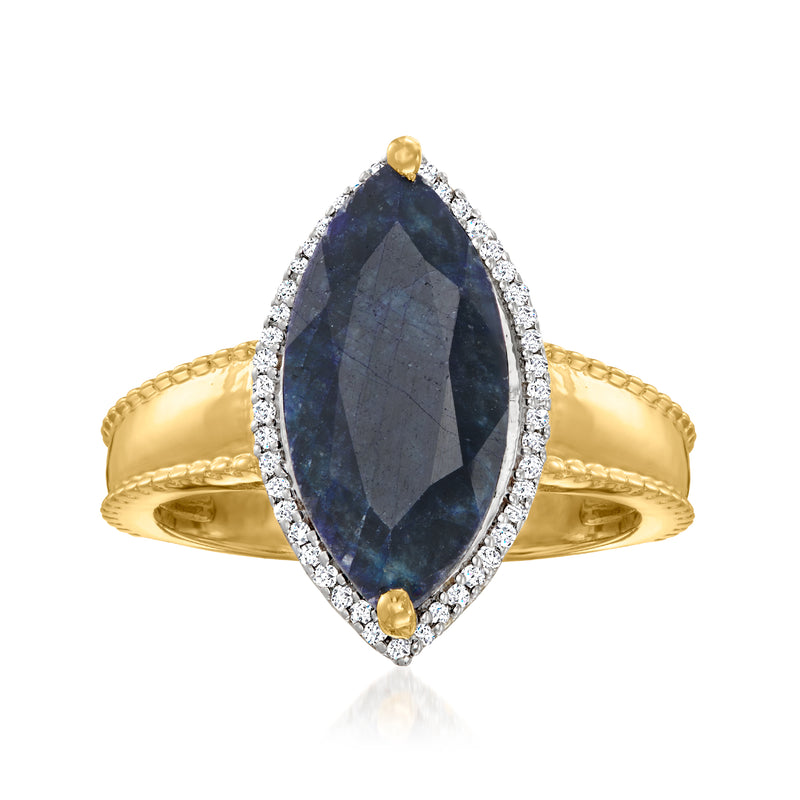 Oval sapphire ring in 18kt gold with diamond halo and small gold side stones