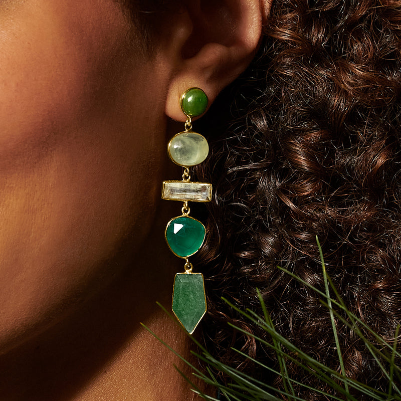 Gold-tone drop earrings with stacked green gemstones on ear: round, oval, rectangle, pear