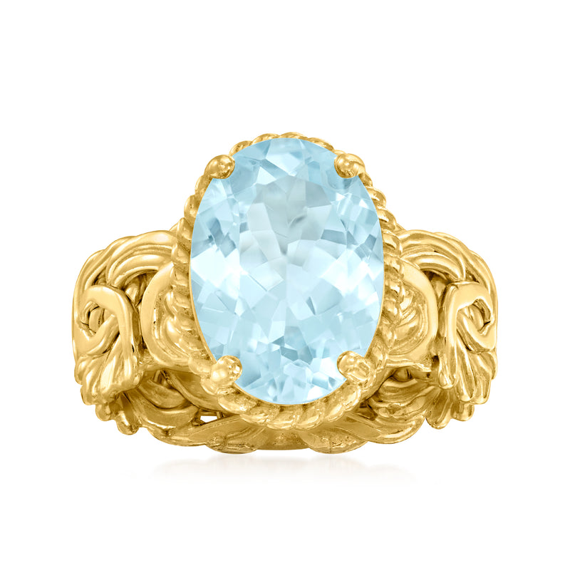 Oval sky-blue topaz ring with ornate byzantine gold-tone setting and faceted gemstone
